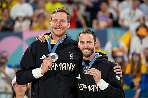 Paris Olympics Men's beach volleyball: Germany's Nils Ehlers, left, and Clemens Wickler celebrate Silver medals
